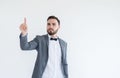 Man in formal suit standing hand touching virtual screen on white background with copy space for text