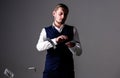 Man in formal wear, businessman throwing money on grey background.