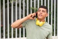 man with freckles, enjoying a cell phone conversation while standing in the city park Royalty Free Stock Photo