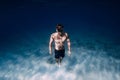 Man freediver underwater in blue ocean in Hawaii. Sporty man