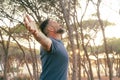 Man with freedom and nature love concept lifestyle opening arms to hug the trees. Sunset sunlight. People and environment. Climate Royalty Free Stock Photo