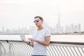 Man freelance programmer and junior developer writes code and thinks about a project in the paradise resort city of Dubai