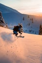 Man freerider fast sliding down snow-covered slopes on fresh powder snow Royalty Free Stock Photo