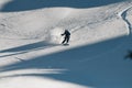 Man freerider with ski quickly slides down a mountain slope covered powdery snow. Royalty Free Stock Photo