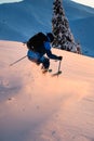 Man freerider sliding down snow-covered slopes on fresh powder snow Royalty Free Stock Photo