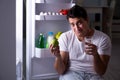 The man at the fridge eating at night Royalty Free Stock Photo