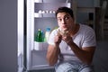 The man at the fridge eating at night Royalty Free Stock Photo