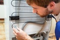 Man during fridge repair Royalty Free Stock Photo