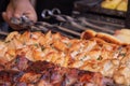 A man fries a barbecue of pork meat and a grill on the back of the chicken meat Royalty Free Stock Photo