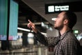 Man In Front Of Arrivals And Departures Board At The Airport. Travel concept Royalty Free Stock Photo