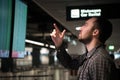 Man In Front Of Arrivals And Departures Board At The Airport. Travel concept Royalty Free Stock Photo