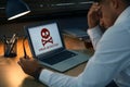 Man in front of laptop with warning about virus attack at workplace Royalty Free Stock Photo