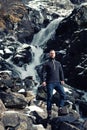 Man in front of Latefossen waterfall in winter, Norway