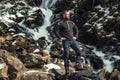 Man in front of Latefossen waterfall in winter, Norway