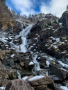 Man in front of Latefossen waterfall in winter, Norway