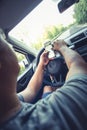 Distracted man traveling and photographing while reckless driving Royalty Free Stock Photo