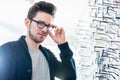 Man in front of shelf with glasses in optician shop Royalty Free Stock Photo