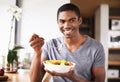 Man, fruit salad and plate in portrait for eating, detox or happy in home kitchen for breakfast. African person, smile Royalty Free Stock Photo