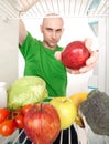 Man and fruits in refrigerator Royalty Free Stock Photo