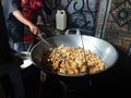 man frying cripsy tofu at big pan, using used cooking oil or minyak jelantah