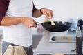 Man with frying pan cooking food at home kitchen Royalty Free Stock Photo