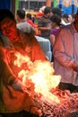 Man frying seafood on a food market in the center of Wuxi, Jiangsu province, China Royalty Free Stock Photo