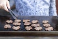 Man frying small round kebabs.