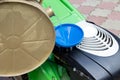 A man is fueling a lawn mower. A green lawnmower. Gardening. Maintenance of equipment