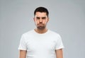 Man with funny angry face over gray background Royalty Free Stock Photo