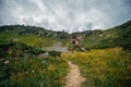 A man funny bounces, jumps, has fun, on the path leading to the top of Mount Spitsy, Carpathian Mountains, nature of Ukraine. Royalty Free Stock Photo