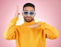 Man, funny dancing and sunglasses for portrait, studio and smile, hands and clothes for aesthetic by pink background Royalty Free Stock Photo