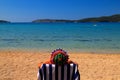 A man in a funny panama sits in a deck chair on a ecological beach under the Blue Flag in Croatia. Summer sea vacation clean sea