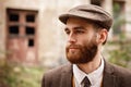 Man gangster in a cap and beard close-up Royalty Free Stock Photo