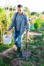 Man gardener digging soil in vegetable garden