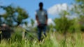 Man gardener mowing the lawn with lawn mower near house. Green grass in the garden on foreground. Male house owner Royalty Free Stock Photo