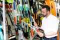 Man with gardening tools in the shop Royalty Free Stock Photo