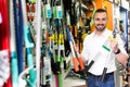 Man with gardening tools in the shop Royalty Free Stock Photo