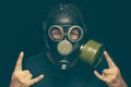 Man in gas mask with crazy eyes making rock sign by both hands Royalty Free Stock Photo