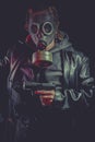 Man with gas mask and gun, dressed in black leather jacket