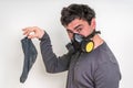 Man with gas mask is holding dirty stinky sock Royalty Free Stock Photo