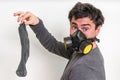 Man with gas mask is holding stinky sock Royalty Free Stock Photo
