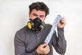 Man with gas mask is holding stinky sock Royalty Free Stock Photo