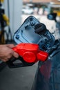 A man gas station attendant pouring fuel in vehicle at the gas station Royalty Free Stock Photo