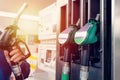 man at the gas station filling the tank of his car with diesel to the top level before a long journey