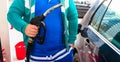 Man at gas station filling up the car with petrol in Bucharest, Romania, 2020