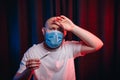 Man in gauze mask holding thermometer and having fever sympthom. Healthcare, respiratory illness prevention