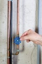 Man gently turning a valve on a water pipe Royalty Free Stock Photo