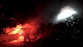 Man geologist with a red burning signal flare exploring underground dark cave, science concept. Stock footage. Scientist