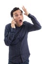 Man gestures on the phone, he is surprised The person is wearing