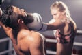 Man get hit by woman Boxer in ring Royalty Free Stock Photo